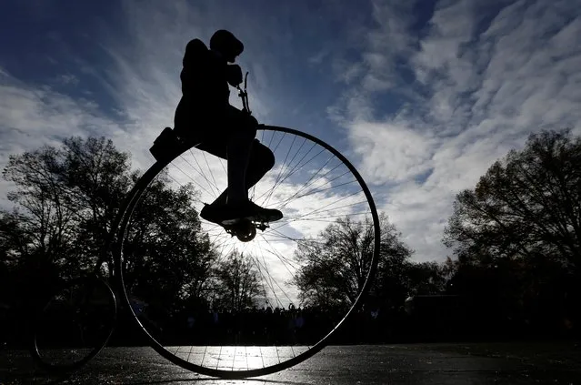 A participant wearing historical costume rides his high-wheel bicycle during the annual penny farthing race in Prague, Czech Republic on November 5, 2022. (Photo by David W. Cerny/Reuters)