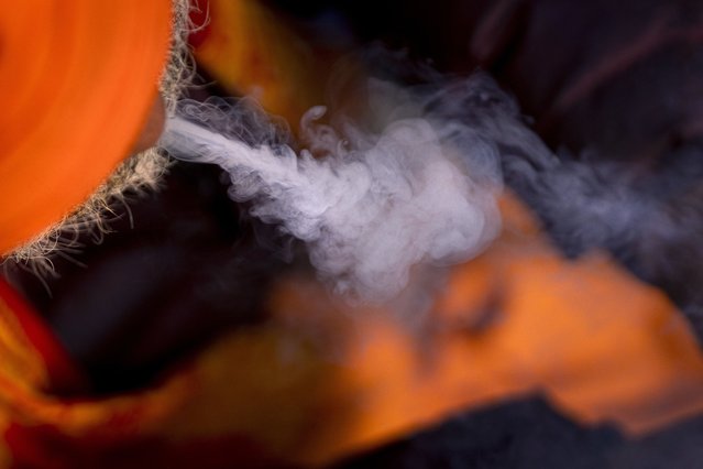 A holy man smokes marijuana at the Pashupatinath Hindu temple during Shivaratri festival in Kathmandu, Nepal, Wednesday, February 26, 2025. (Photo by Niranjan Shrestha/AP Photo)