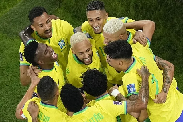 Teammates celebrate with Brazil's Neymar, center, who scored his side's second goal during the World Cup round of 16 soccer match between Brazil and South Korea, at the Education City Stadium in Al Rayyan, Qatar, Monday, December 5, 2022. (Photo by Pavel Golovkin/AP Photo)