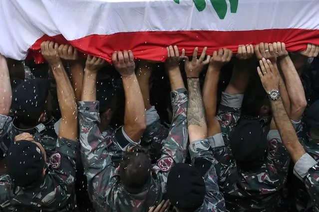 Firefighters carry the coffin of their friend Joe Noun, one of ten firefighters who were killed during the explosion that hit the Beirut port, during his funeral at the firefighter headquarters, in Karantina Beirut, Lebanon, 12 Auguat 2020. Lebanese Health Ministry said at least 171 people were killed, and more than 6000 injured in the Beirut blast that devastated the port area on 04 August and believed to have been caused by an estimated 2,750 tons of ammonium nitrate stored in a warehouse. (Photo by Wael Hamzeh/EPA/EFE)