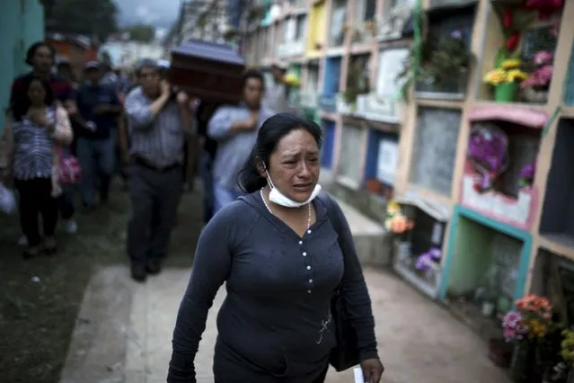 Relatives participate in the burial of Santos Etelvina Sontay, a victim of a mudslide in Santa Catarina Pinula, on the outskirts of Guatemala City, October 5, 2015. (Photo by Jose Cabezas/Reuters)