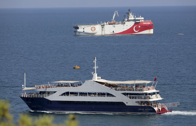 Turkey's research vessel, Oruc Reis, rear, anchored off the coast of Antalya on the Mediterranean, Turkey, Sunday, September 13, 2020. Greece's Prime Minister Kyriakos Mitsotakis welcomed the return of a Turkish survey vessel to port Sunday from a disputed area of the eastern Mediterranean that has been at the heart of a summer stand-off between Greece and Turkey over energy rights. (Photo by Burhan Ozbilici/AP Photo)