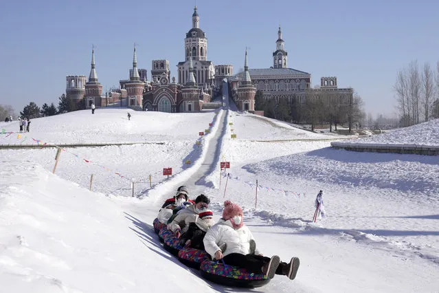 People enjoy themselves at the Volga Manor in Harbin, northeast China's Heilongjiang Province, January 26, 2023. The Volga Manor, a Russian culture-themed park, turned into an ice and snow world during the Spring Festival, attracting lots of visitors. (Photo by Xinhua News Agency/Rex Features/Shutterstock)