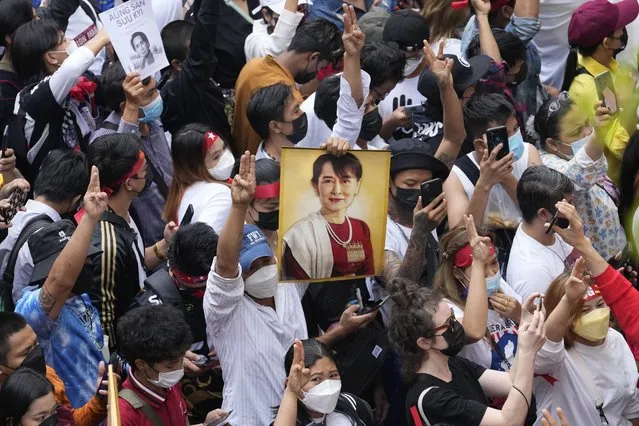 Myanmar nationals living in Thailand hold a picture of former Myanmar leader Aung San Suu Kyi during protest marking the two-year anniversary of the military takeover that ousted her government outside the Myanmar Embassy in Bangkok, Thailand, Wednesday, February 1, 2023. (Photo by Sakchai Lalit/AP Photo)