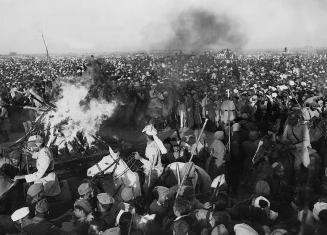 Gandhis funeral pyre - Indian soldiers, cavalry and police use their rifles, lathis and clubs to force back the crowd who surged forward after Mahatma Gandhis sandalwood funeral pyre had been lit on the banks of the Jumna River, New Delhi, January.31, 1948. (Photo by AP Photo)