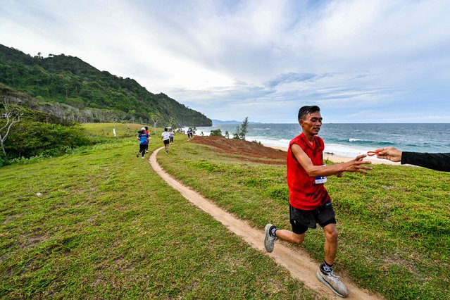 Runners participate in the Lhoknga Trail Run 2025, crossing a former guerrilla route and along the 2004 tsunami-affected coastline in Lhoknga, Aceh province on August 31, 2025. (Photo by Chaideer Mahyuddin/AFP Photo)