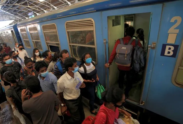 Sri Lankan commuters wearing face masks wait to get in to the train at the Fort Railway Station, Colombo, Sri Lanka, on October 05, 2020. Sri Lankan authorities closed schools countrywide and imposed a curfew on Sunday in three suburbs in Western Province, after a person tested positive for the coronavius following which 81 new Covid19 positive cases were reported so far today (05) in Sri Lanka. (Photo by Tharaka Basnayaka/NurPhoto via Getty Images)