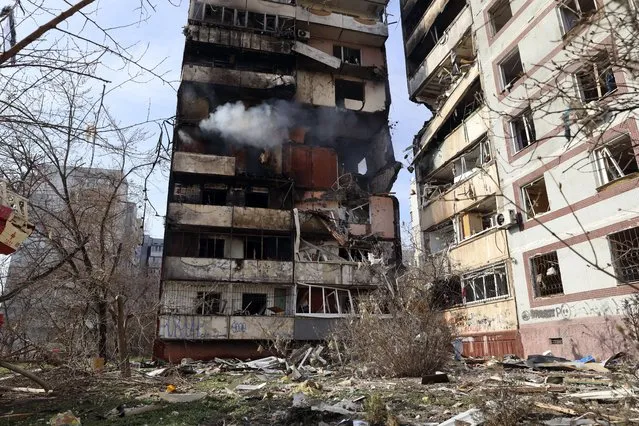 A residential multi-story building is seen damaged after a Russian missile hit it in southeastern city of Zaporizhzhia, Ukraine, Wednesday, March 22, 2023. (Photo by Kateryna Klochko/AP Photo)