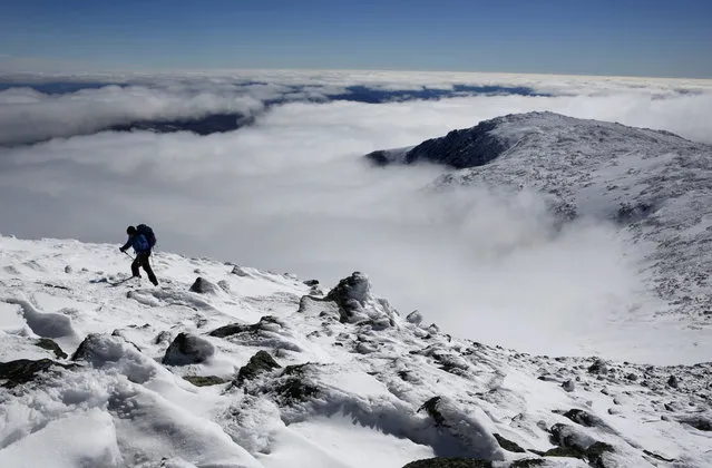 Clouds fill Tuckerman Ravine below Peter Arthur as he makes the final push to the summit of 6,288-foot Mount Washington, Tuesday, March 6, 2018, near Pinkham Notch, N.H. “I saw the weather forecast and knew I had to take the day off from work”, said Arthur, who drove 6.5 hours through the night from his home in Remsen, N.Y. A second nor'easter in as many weeks is expected to hit New England on Wednesday. (Photo by Robert F. Bukaty/AP Photo)