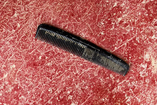 This photo taken on December 17, 2014, shows a comb found during the exhumation of a mass grave of those killed by their political ideology during and after the spanish civil war at the Puerto Real cemetery is displayed to be pictured by the photographer in Puerto Real, Spain. (Photo by Daniel Ochoa de Olza/AP Photo)