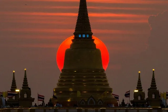 The sun sets behind Wat Saket Temple, or Golden Mount in Bangkok, Thailand on March 19, 2023. (Photo by Athit Perawongmetha/Reuters)