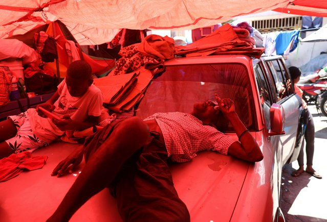 A man sleeps on a car at a shelter for families displaced by gang violence in Port-au-Prince, Haiti, Thursday, June 5, 2025. (Photo by Odelyn Joseph/AP Photo)