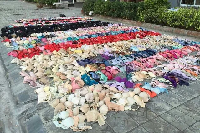 Hundreds of stolen women's underwear are placed on the ground after being found hidden in the ceiling of a apartment building, in Yulin, Guangxi Zhuang Autonomous Region, December 19, 2014. A Chinese man who stole hundreds of pieces of ladies' underwear had his secret exposed after an emergency exit ceiling where he had been storing his hoard collapsed, state media reported. (Photo by Reuters/Stringer)