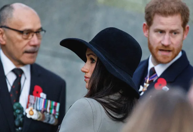 Meghan Markle, centre, attends an Anzac Day dawn service with Britain's Prince Harry, right,  at Hyde Park Corner in London, Wednesday, April 25, 2018. ANZAC Day commemorates the moment when Australian and New Zealand Army Corps troops waded ashore at the Gallipoli peninsula in Turkey 103 years ago in their first major battle of World War I. (Photo by Tolga Akmen/Pool Photo via AP Photo)