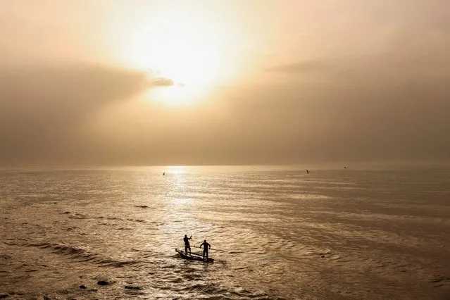 Palestinian fishermen take to the sea at sunset in Gaza city, on April 10, 2023. (Photo by Mohammed Abed/AFP Photo)