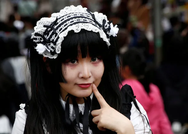 Hamuka dressed in “Lolita fashion”, influenced by Victorian style, poses for photographs at Harajuku shopping district in Tokyo, Japan March 15, 2018. (Photo by Kim Kyung-Hoon/Reuters)