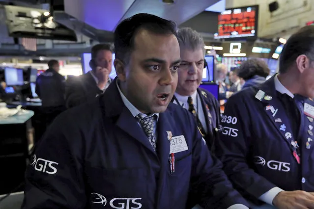 Specialist Dilip Patel, left, works at his post on the floor of the New York Stock Exchange, Monday, March 9, 2020. The Dow Jones Industrial Average sank 7.8%, its steepest drop since the financial crisis of 2008, as a free-fall in oil prices and worsening fears of fallout from the spreading coronavirus outbreak seize markets. (Photo by Richard Drew/AP Photo)