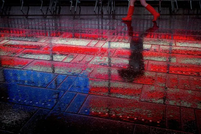 A woman walks through the rain in Times Square in Manhattan, New York, October 2, 2015. (Photo by Andrew Kelly/Reuters)