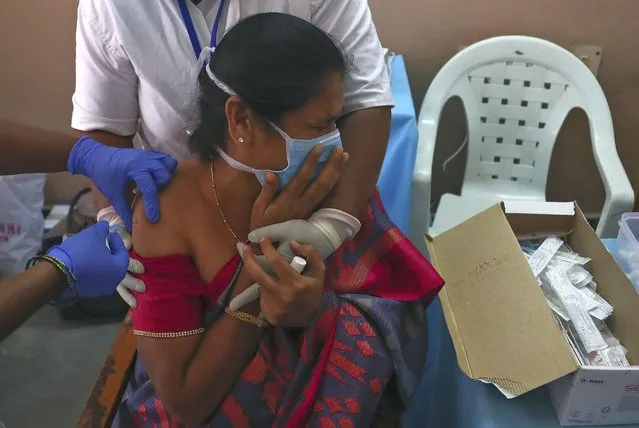 A hospital staff receives a COVID-19 vaccine at a government Hospital in Hyderabad, India, Friday, January 22, 2021. India kicked off its massive vaccination drive on Jan. 16, with a goal of inoculating 300 million of its nearly 1.4 billion people. (Photo by Mahesh Kumar A./AP Photo)