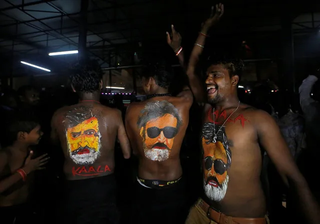 Fans with their bodies painted with images of actor Rajinikanth dance as they celebrate the release of his new movie “Kaala” in Mumbai, India, June 7, 2018. (Photo by Francis Mascarenhas/Reuters)
