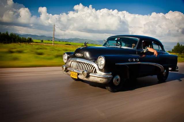 “Cruising in Cuba”. The National Highway in Cuba has many stretches where you will not see another car for miles. Then when you do see one, it is an old classic like this 1950's Buick which looks at home on the open road with the Cuban landscape of fields and mountains in the distance. (Photo and caption by James Kao/National Geographic Traveler Photo Contest)