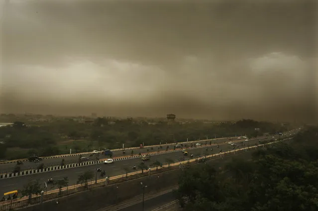 A dust storm accompanied by rains are seen over Lucknow's skyline, India, Monday, June 18, 2018. India is currently having its monsoon season that lasts till September. (Photo by Rajesh Kumar Singh/AP Photo)