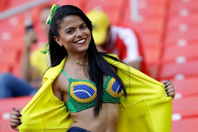 A Brazil supporter poses as she waits for the beginning of the group E match between Serbia and Brazil, at the 2018 soccer World Cup in the Spartak Stadium in Moscow, Russia, Wednesday, June 27, 2018. (Photo by Andre Penner/AP Photo)