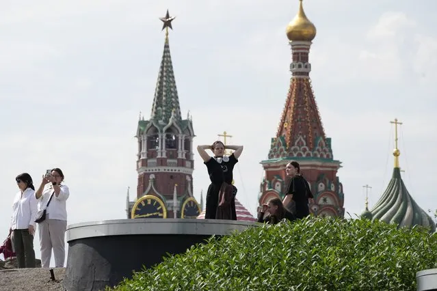 People walk in a park near the Kremlin in Moscow, Russia, Monday, June 26, 2023, on a day declared a holiday due to the situation in the country. (Photo by Dmitri Lovetsky/AP Photo)