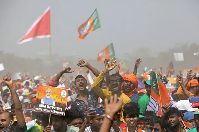 Bharatiya Janata Party (BJP) supporters hold party flags during a rally by the Indian prime minister Narendra Modi at Brigade Parade Ground in Kolkata, India, 07 March 2021. Prime minister Narendra Modi held a rally for Bharatiya Janata Party (BJP) campaign in the poll-bound West Bengal. (Photo by Piyal Adhikary/EPA/EFE)