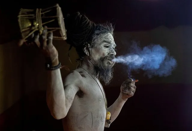 A Naga Sadhu, or Hindu holy man, waits before the procession for taking a dip in the Ganges river during Shahi Snan at “Kumbh Mela”, or the Pitcher Festival, in Haridwar, India, April 12, 2021. (Photo by Danish Siddiqui/Reuters)