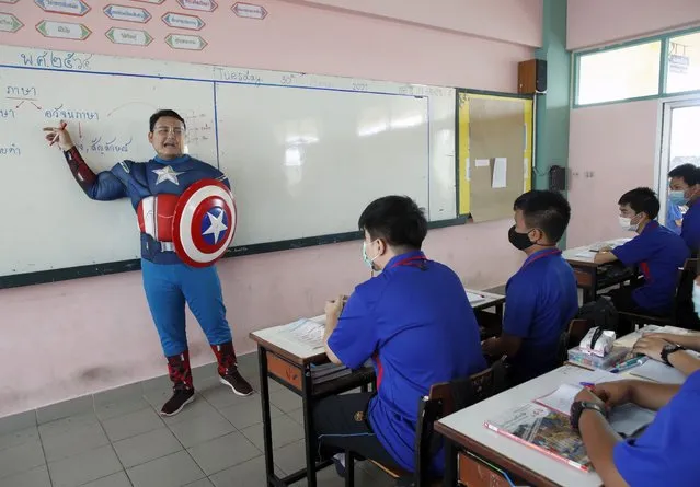 Thai teacher Sattawat Kongsang dressed in cosplay as Captain America teaches students in a classroom at Prataungtipvittaya School in Bangkok, Thailand, 30 March 2021. Teachers of the school in Bangkok occasionally wear cosplay costumes of various anime and comic superhero characters as Captain America, Demon Slayer, Harry Potter and Xuan Zang while conducting interview tests, examinations and teaching in the classroom aimed to relax and reduce student's stress to encourage the class to engage more in the lessons. (Photo by Rungroj Yongrit/EPA/EFE)
