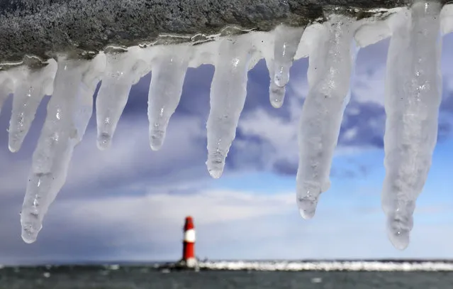 Icicles photographed in the Baltic Sea harbor of Warnemuende, near Rostock, eastern Germany, Monday, February 26, 2018. Snow and freezing sub-zero temperatures have a grasp on some parts of Germany as meteorologists reported a new cold record of minus 27 degrees Celsius (minus 16.6 Fahrenheit) for this winter on Zugspitze mountain in the Alps. (Photo by Bernd Wuestneck/DPA via AP Photo)
