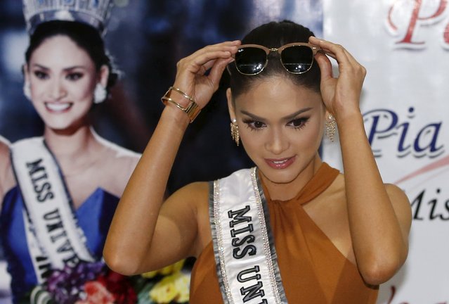 Miss Universe 2015 Pia Wurtzbach of the Philippines removes her sunglasses before speaking to the media, after her arrival at the Ninoy Aquino International Airport in Pasay City, Metro Manila January 23, 2016. (Photo by Erik De Castro/Reuters)