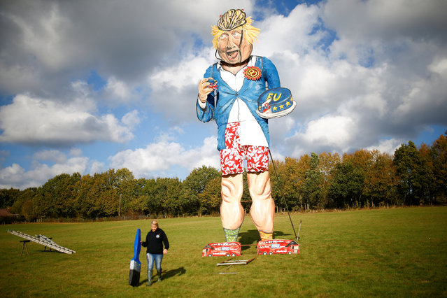 Artist Andrea Deans poses with the 11-metre effigy of Boris Johnson unveiled today ahead of the Edenbridge Bonfire Celebrations in Edenbridge, Britain October 31, 2018. (Photo by Henry Nicholls/Reuters)