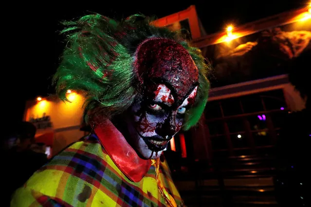 A participant in costume and make-up poses for a photo during a Halloween parade at Walibi park in Wavre, Belgium, October 31, 2018. (Photo by Yves Herman/Reuters)
