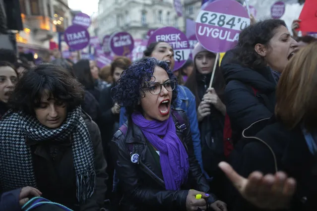 Protesters, mostly women, display placards and chant slogans during a rally in central Istanbul, Sunday, November 25, 2018, to mark the United Nations' International Day for the Elimination of Violence Against Women. (Photo by Lefteris Pitarakis/AP Photo)