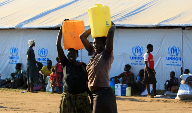 Women who fled fighting in South Sudan carry water in plastic container on arrival at Bidi Bidi refugee’s resettlement camp near the border with South Sudan, in Yumbe district, northern Uganda December 7, 2016. (Photo by James Akena/Reuters)