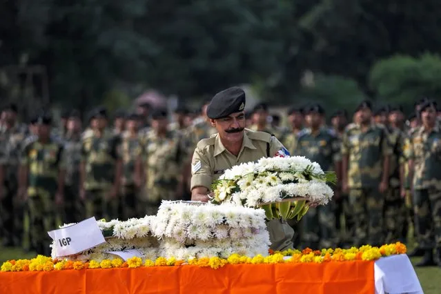 Indian Border Security Force (BSF) soldiers pay tribute to their colleague Lal Fam Kima during a wreath-laying ceremony at the BSF headquarters in Jammu, India, Thursday, November 9, 2023. The BSF soldier was killed as Indian and Pakistani soldiers exchanged gunfire and shelling along their highly militarized frontier in disputed Kashmir. (Photo by Channi Anand/AP Photo)