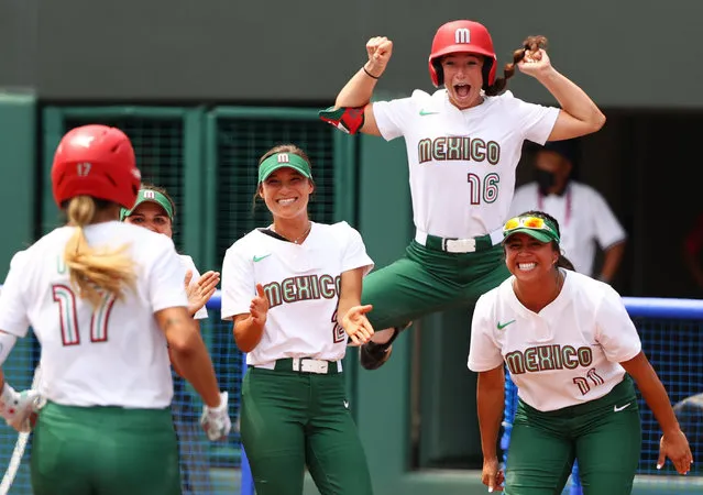 Tatyana Forbes of Mexico jumps to celebrate home run by Anissa Urtez of Mexico during the Softball Opening Round of the Tokyo 2020 Olympic Games at Fukushima Azuma Baseball Stadium on July 22, 2021 in Fukushima, Japan. (Photo by Jorge Silva/Reuters)