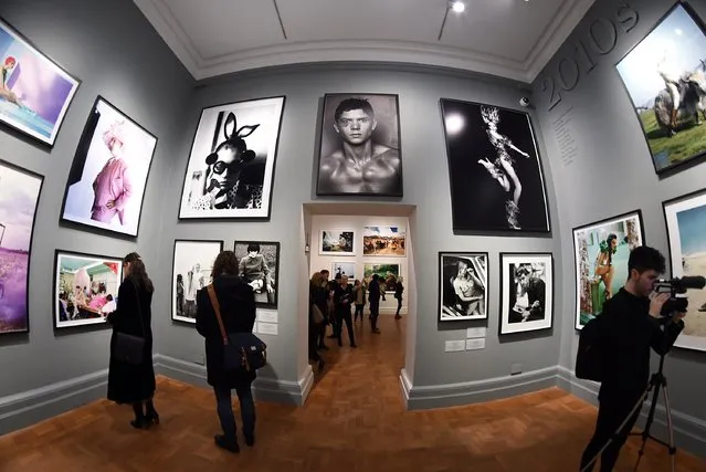 Journalists attend the press preview for “Vogue 100: A Century of Style” exhibiting the photographs that has been commissioned by British Vogue since it was founded in 1916 at National Portrait Gallery on February 10, 2016 in London, England. (Photo by Stuart C. Wilson/Getty Images)