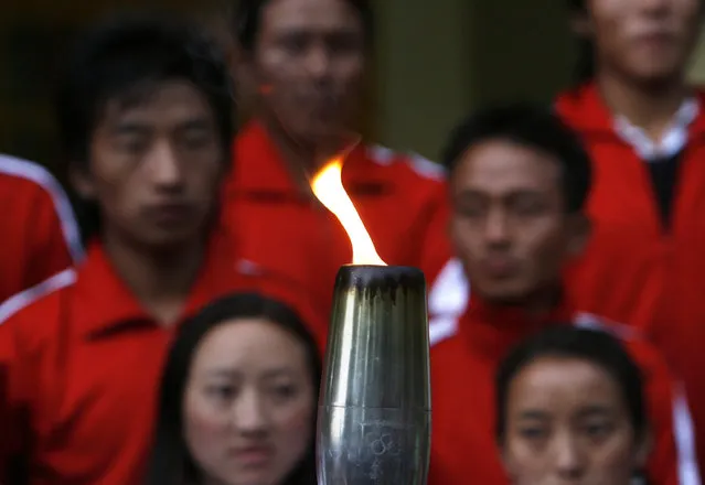 Tibetan exiles hold the Tibetan Olympics 2008 torch during a symbolic relay in the northern hill town of Dharamsala, May 2008. (Photo by Desmond Boylan/Reuters)