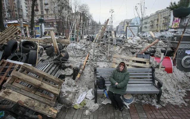 A woman sits near a barricade at the Khreschatyk main street where pro-European integration protesters hold a rally, in central Kiev December 13, 2013. Ukrainian President Viktor Yanukovich made few concessions on Friday in crisis talks with the opposition, his first direct attempt to defuse weeks of unrest over a policy swerve to Russia away from Europe. (Photo by Gleb Garanich/Reuters)