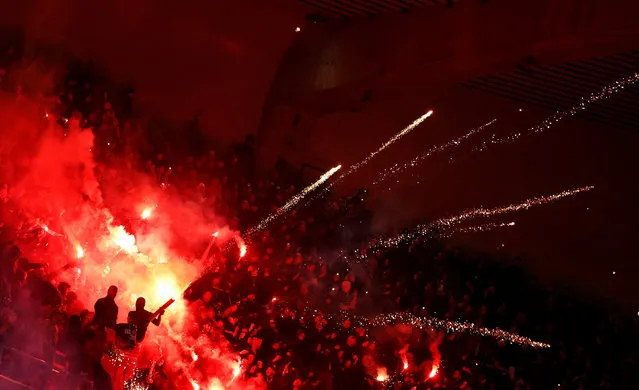 Paris Saint-Germain fans light flares in the stands during a match against Nantes in the French capital on December 9, 2023. (Photo by Sarah Meyssonnier/Reuters)