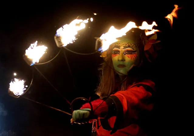 A member of the Beltane Fire Society takes part in the Samhuinn Fire Festival at Holyrood Park in Edinburgh, Scotland, Britain on October 31, 2022. (Photo by Lee Smith/Reuters)