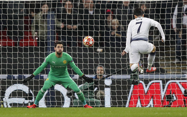 Tottenham midfielder Heung-Min Son, right, scores the opening goal against Dortmund goalkeeper Roman Buerki during the Champions League round of 16, first leg, soccer match between Tottenham Hotspur and Borussia Dortmund at Wembley stadium in London, England, Wednesday, February 13, 2019. (Photo by Frank Augstein/AP Photo)