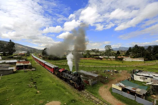 A “La Sabana” tourist train steam locomotive manufactured in 1934 crosses farmland in La Caro village near Bogota, March 8, 2015. (Photo by Jose Miguel Gomez/Reuters)