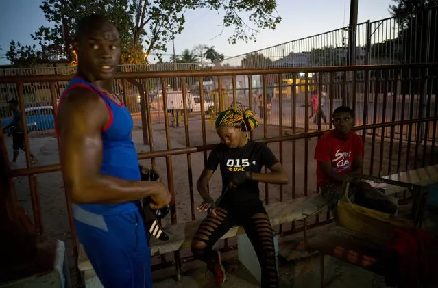 In this January 24, 2017 photo, Olympic silver medalist Emilio Correa Jr., left, mentors female boxer Legnis Cala, center, at a sports center in Havana, Cuba. “They can bring more glory to the Cuban sport”, Correa said. “They are diamonds in the rough. The motor skills, the explosive nature and the energy of Cuban boxers are also present in these women”. (Photo by Ramon Espinosa/AP Photo)