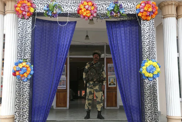 An Indian soldier keeps vigil at a polling station during the second phase of India's general elections, on the outskirts of Srinagar, Indian controlled Kashmir, Thursday, April 18, 2019. Kashmiri separatist leaders who challenge India's sovereignty over the disputed region have called for a boycott of the vote. Most polling stations in Srinagar and Budgam areas of Kashmir looked deserted in the morning with more armed police, paramilitary soldiers and election staff present than voters. (Photo by Mukhtar Khan/AP Photo)