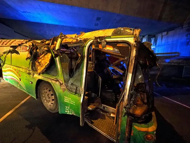 The wreckage of the tourist coach which crashed near Taipei, Taiwan, early 14 February 2017. A tourist coach carrying about 44 people crashed off a highway near Taipei on 13 February, leaving at least 32 dead. The coach crashed through the highway railing and flipped over off a slope, according to media reports. The tourists were on their way home after having visited the Wuling Farm in Taichung County to see cherry blossoms. (Photo by David Chang/EPA)