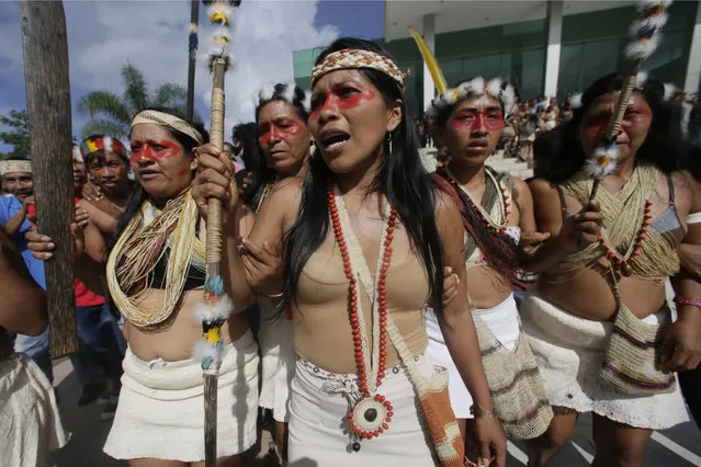 Waoranis and leader Nemonte Nenquimo leave a courthouse after a judged ruled in their favor in a lawsuit filed against the Ministry of Non-Renewable Natural Resources for opening up oil concessions on their ancestral land, in Puyo, Ecuador, Friday, April 26, 2019. The Amazon tribe has won an early court victory in its fight to stop oil extraction in its ancestral territory. A judge in a provincial court determined Friday that the Waorani people have a right to be consulted before any oil drilling takes place. (Photo by Dolores Ochoa/AP Photo)